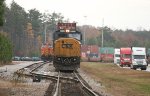 With BNSF 4134 behind, CSX 8735 leads a line of containers
